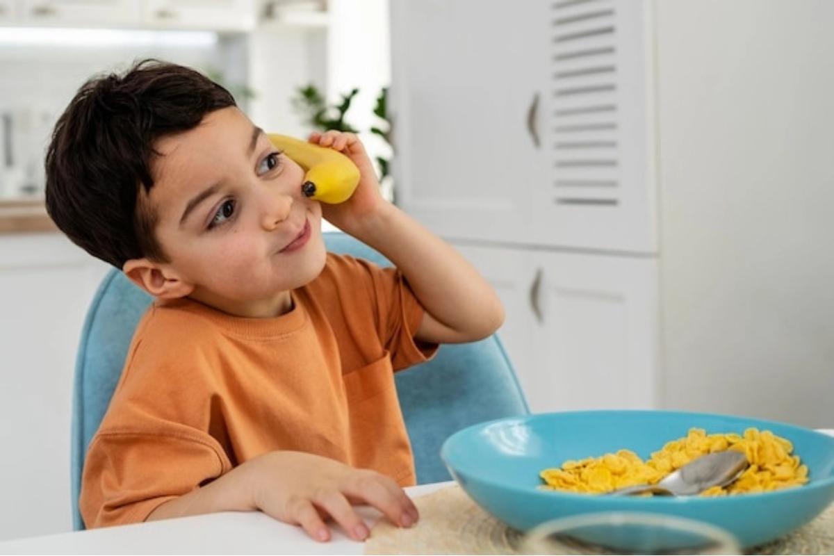 Anak laki-laki bermain dengan pisang